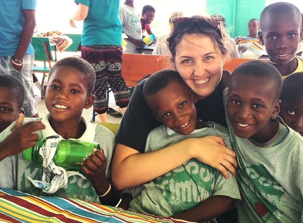 J'Lyn Emerson poses with children in Haiti.