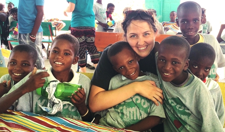 J'Lyn Emerson poses with children in Haiti.