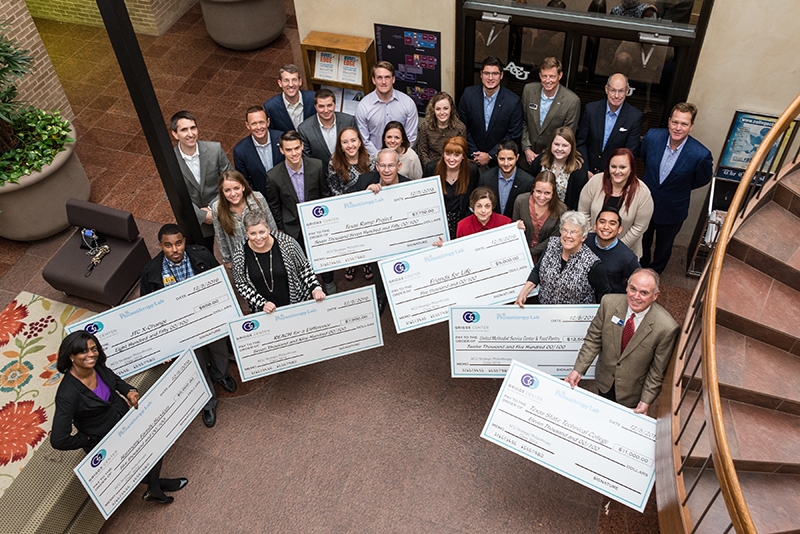 Members of the Strategic Philanthropy course at ACU present checks to local nonprofit organizations.