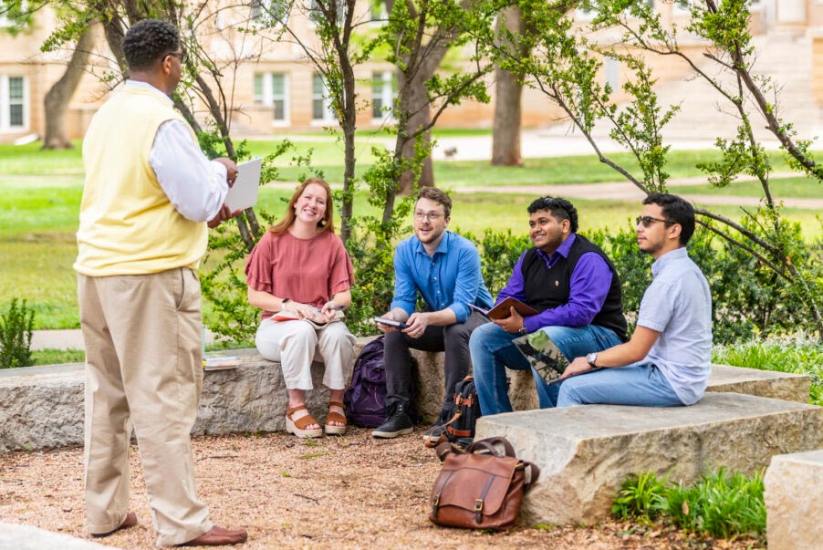 professor teaching students outside on ACU's campus
