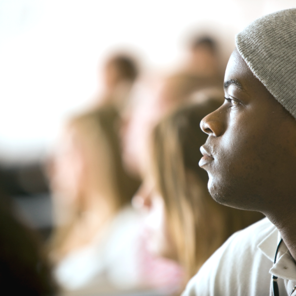 A student wearing a gray hat attending a management class