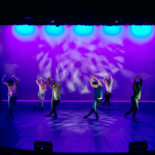 A group of theatre major students dancing on stage