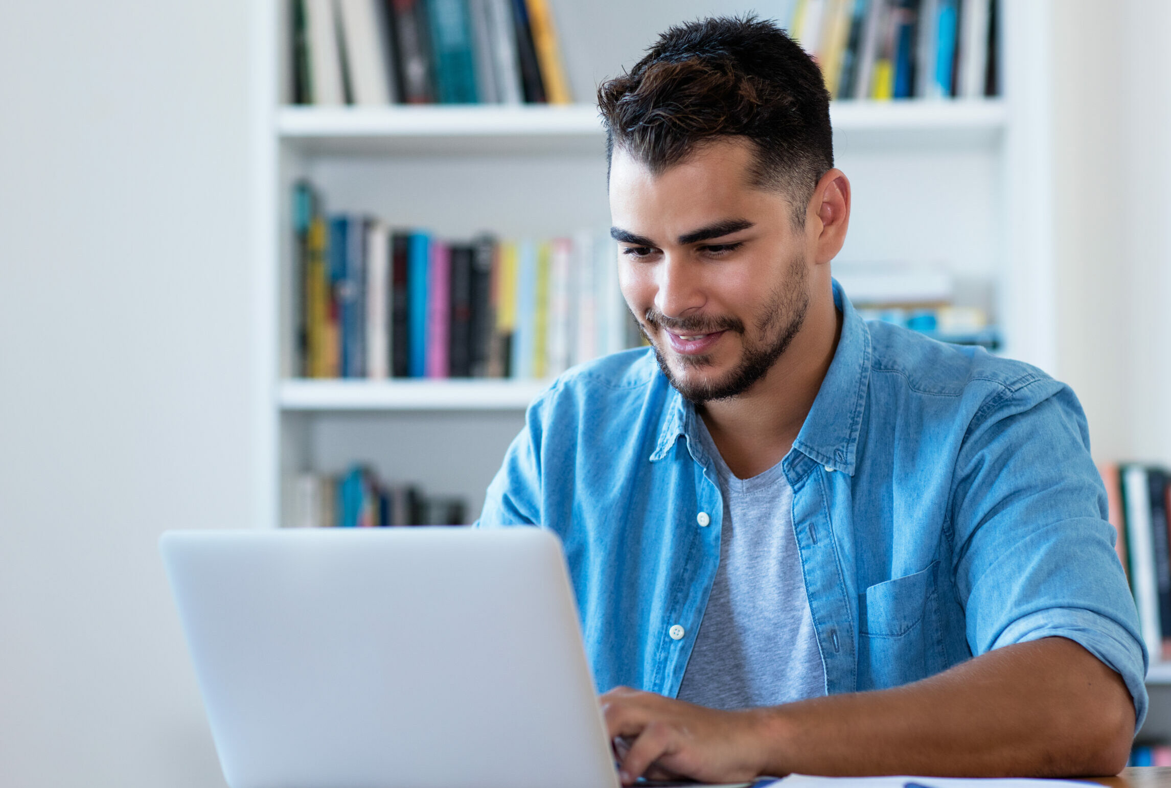 man sending email with laptop, earning an online bachelor’s degrees