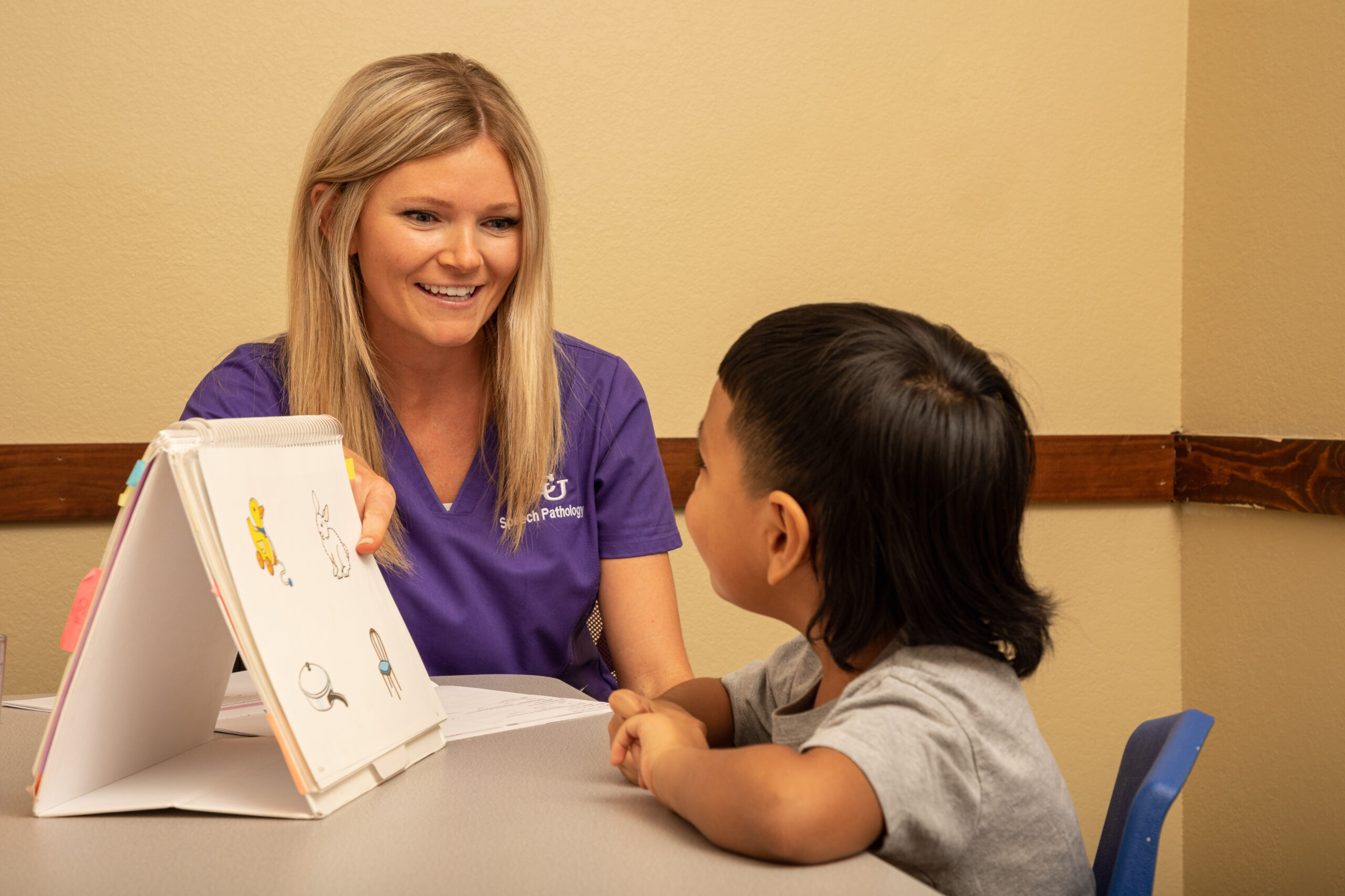 An ACU College of Education and Human Services student teaching a young child