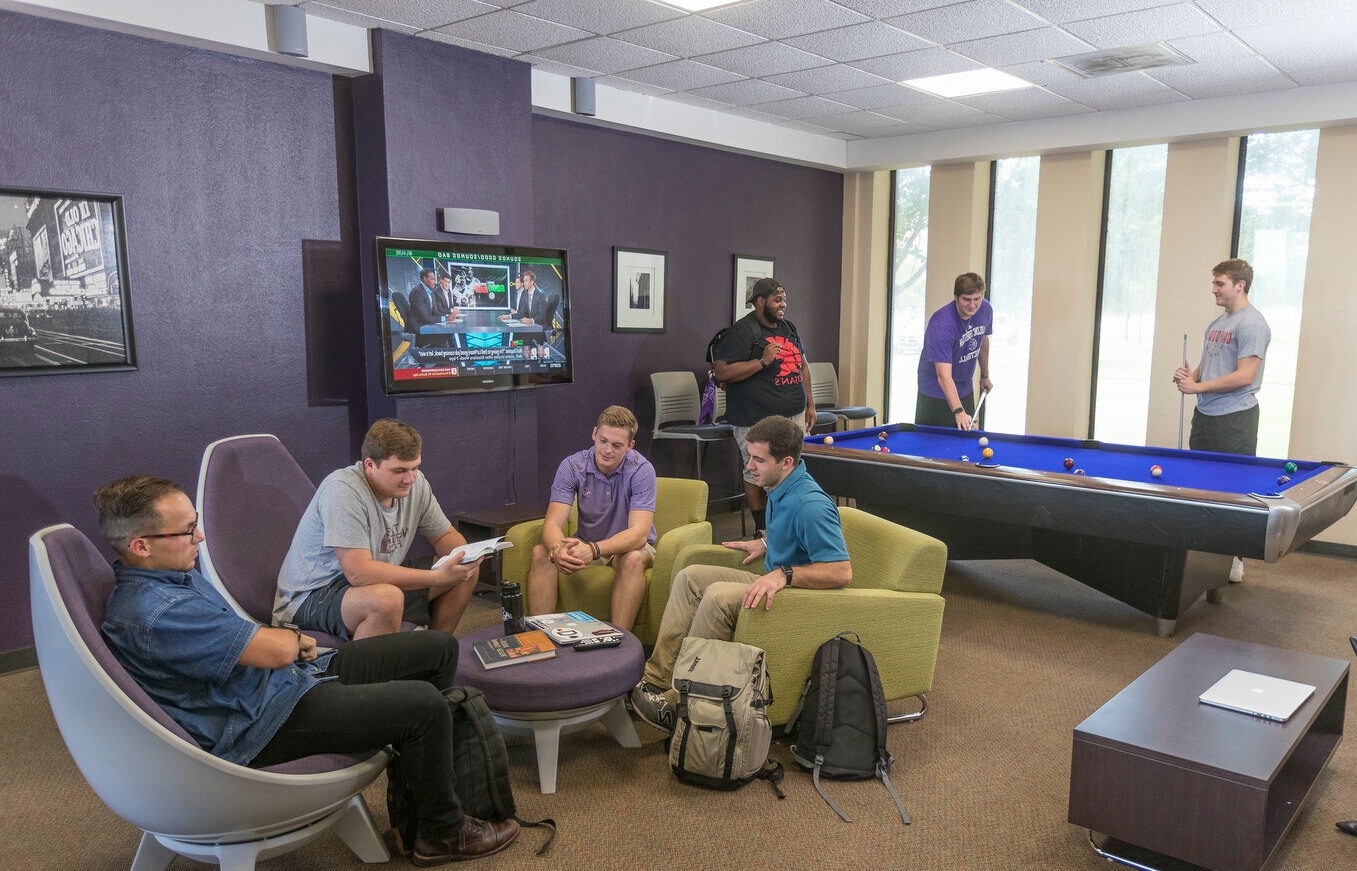 Students hanging out at the game room of the residential hall