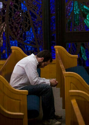 A student praying in church
