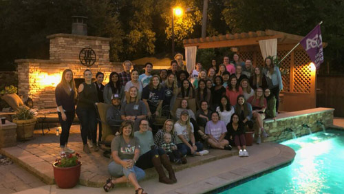 Students and faculty at a poolside social - occupational therapy