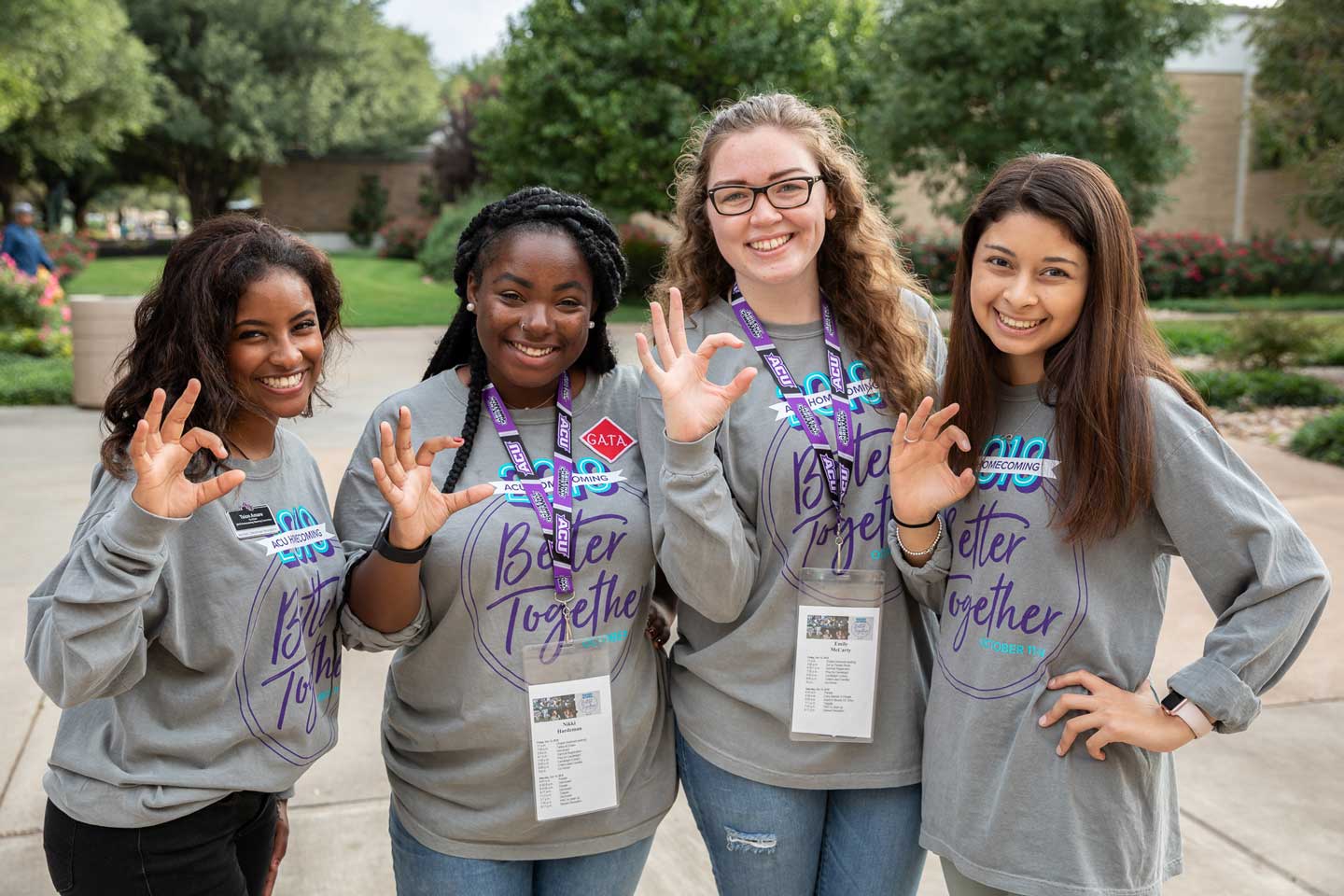 Students making the ACU Wildcat sign