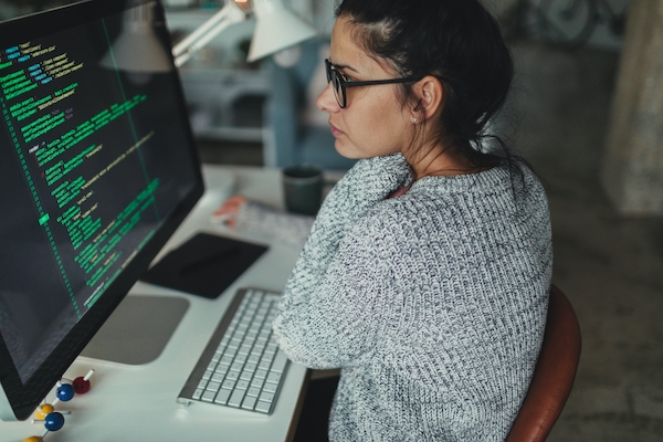 Young woman programming at her home office, Master of Science in Information Technology