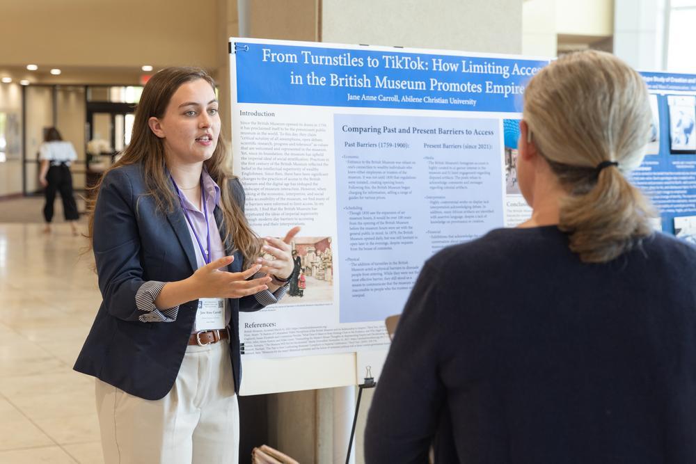 A student presenting a poster at the Undergraduate Research Festival.