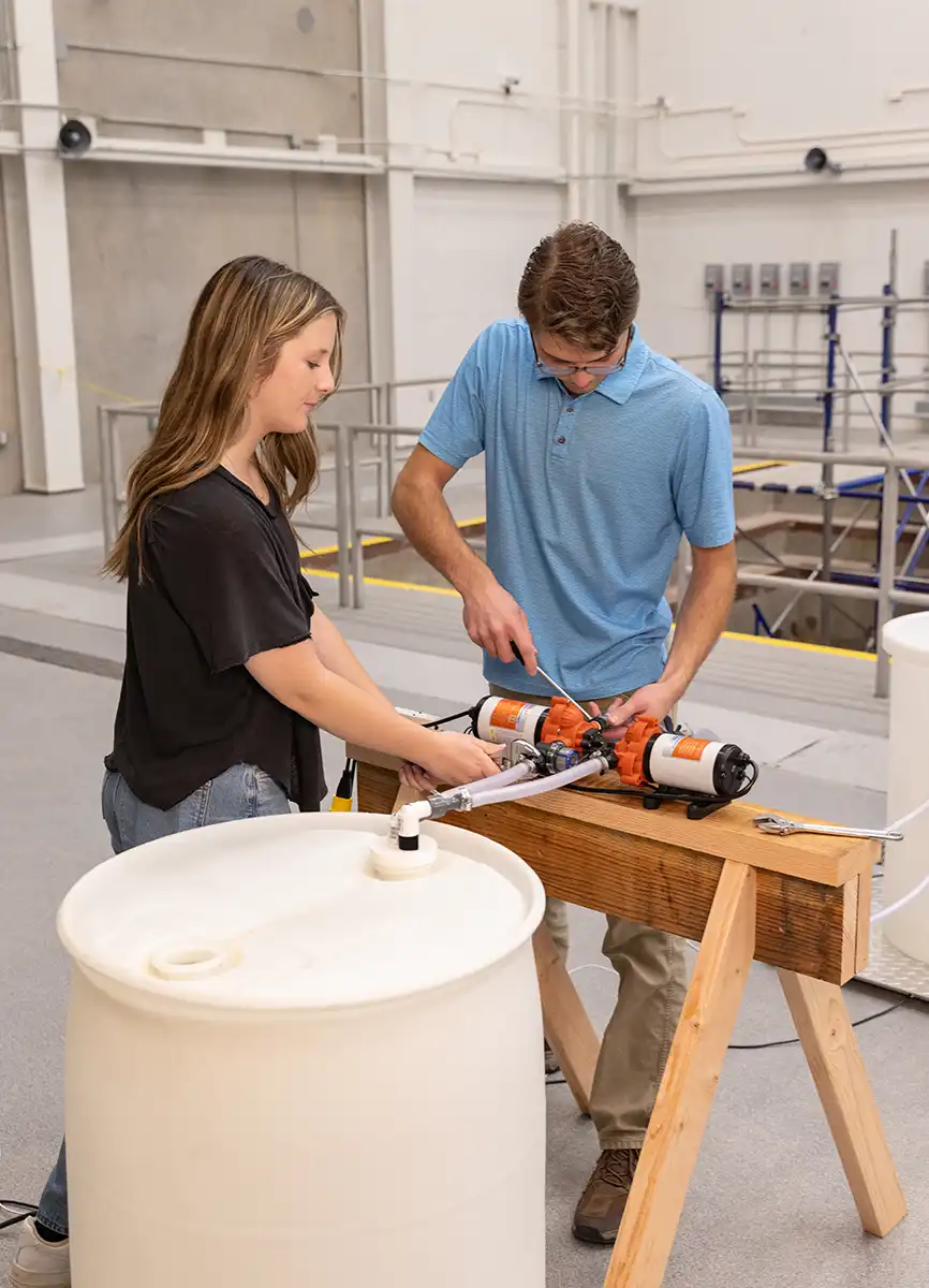 Engineering students work on a piece of equipment in the NEXT Lab.