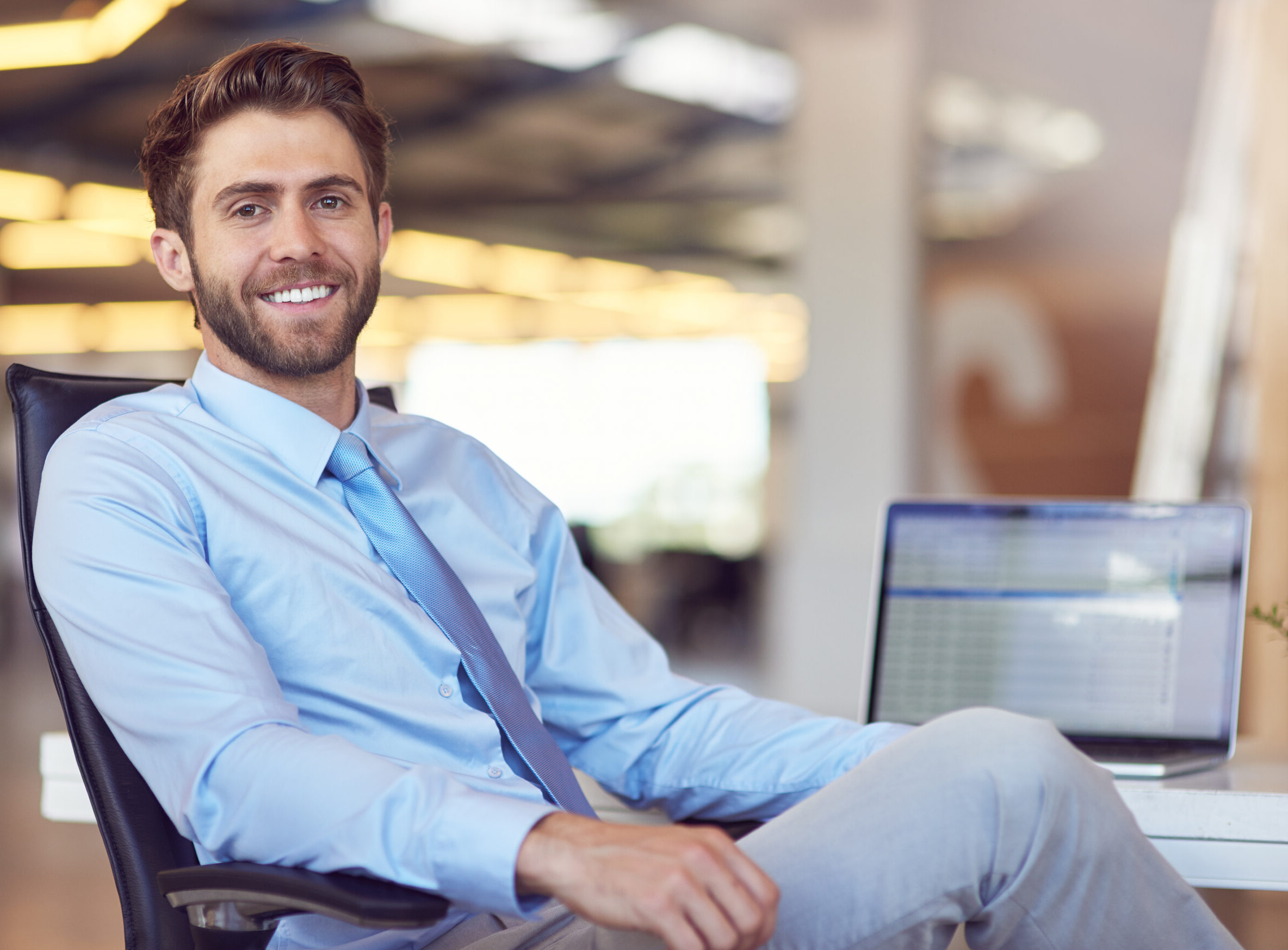 Man sitting at desk with laptop