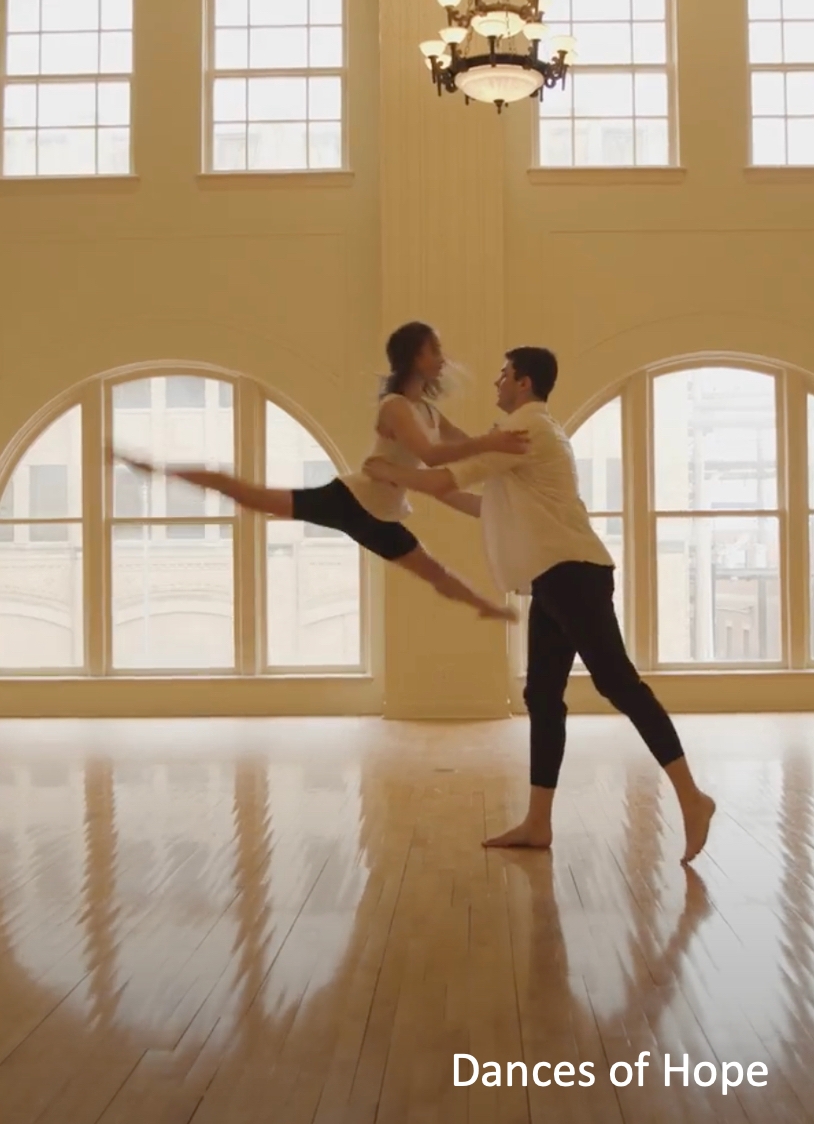 Man lifts dance partner up while rehearsing.