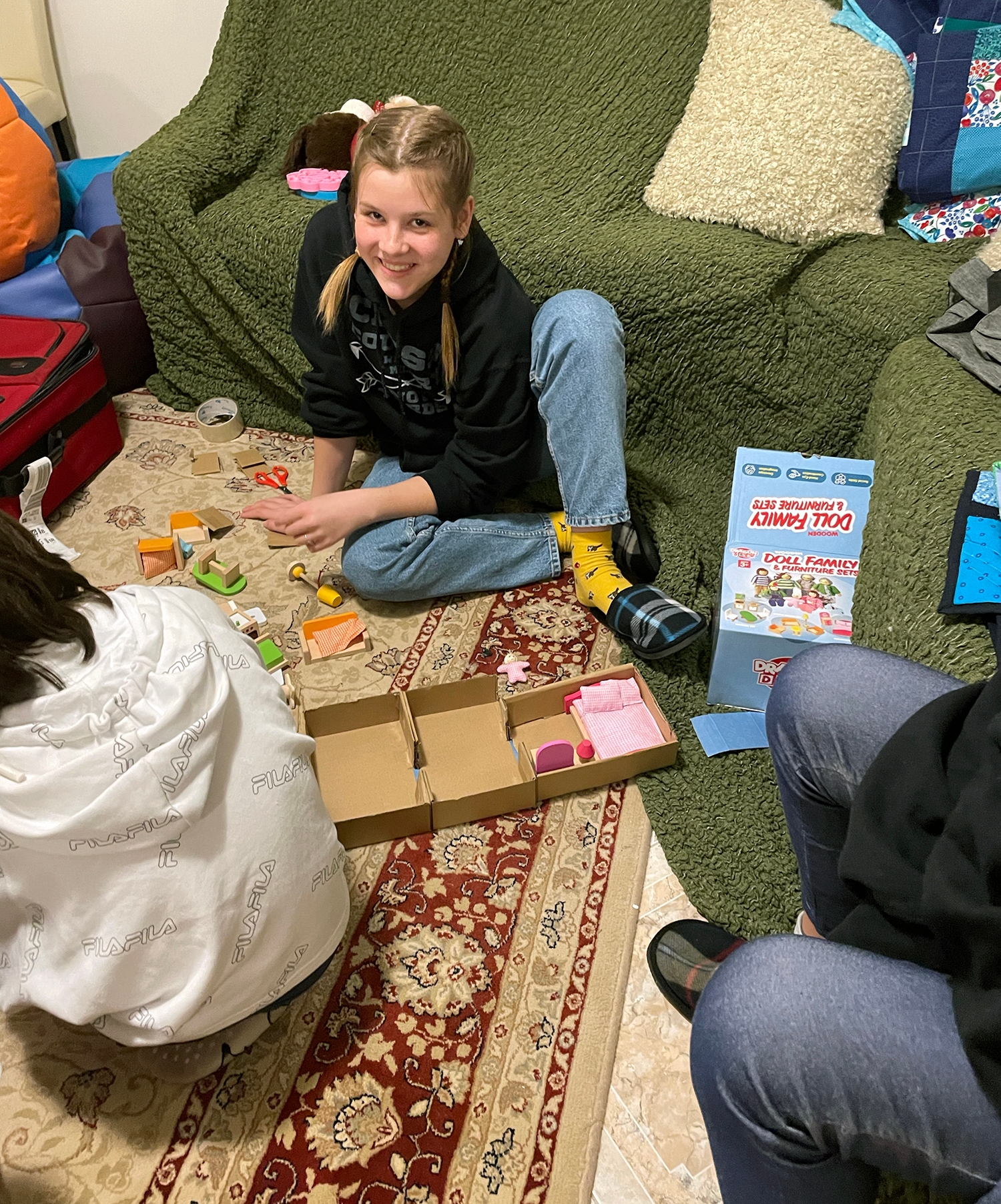 Vika, who just turned 13, gets ready to set up the dollhouse furniture during a play therapy session with Jenny.