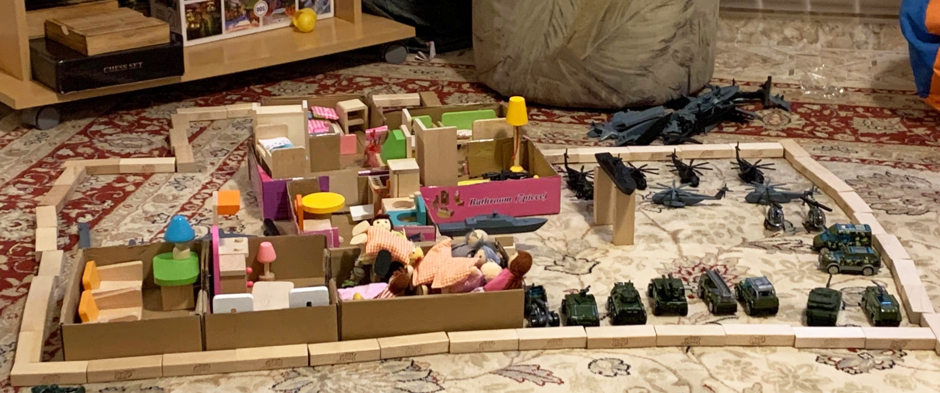During play therapy, the children construct a scene showing the Ukrainian army guarding people huddled in one room.