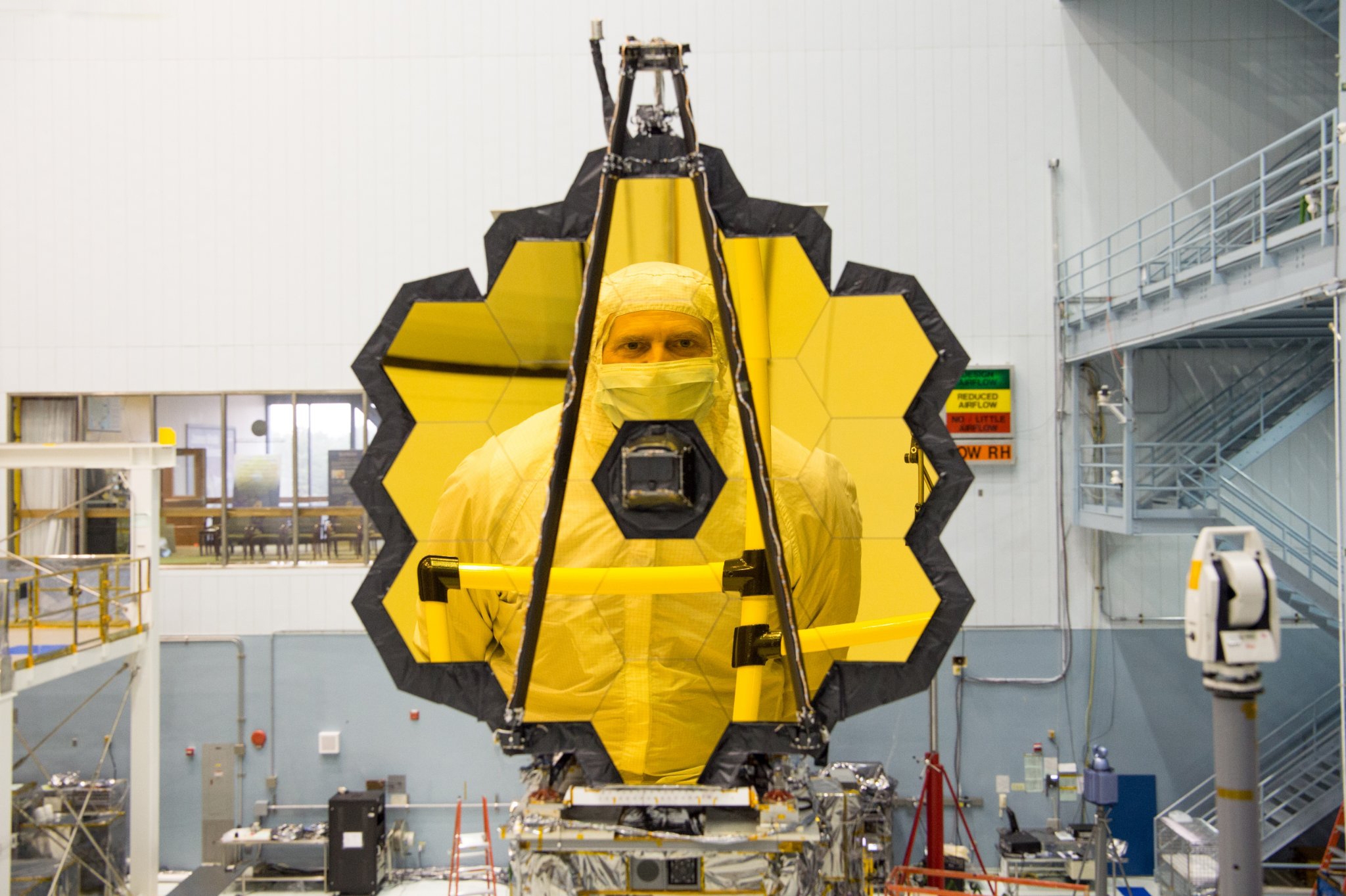 Dr. Scott Acton is reflected in the primary mirror of the James Webb Space Telescope.