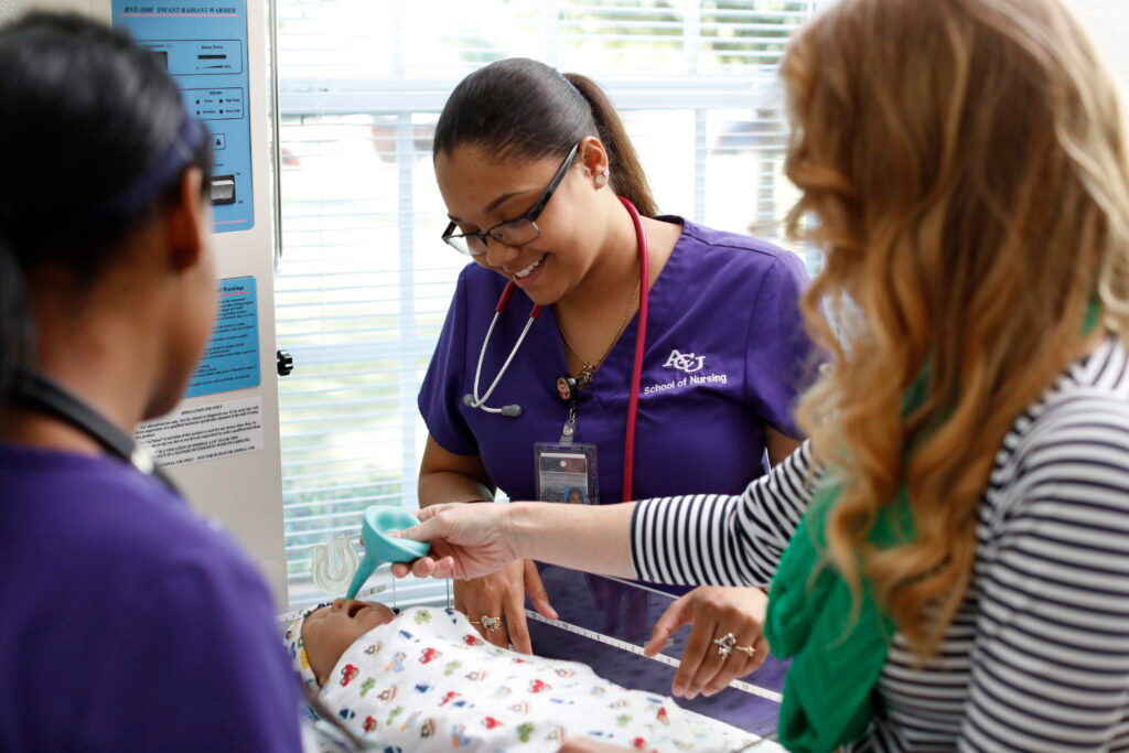 ACU nursing students learning how to provide health care to an infant