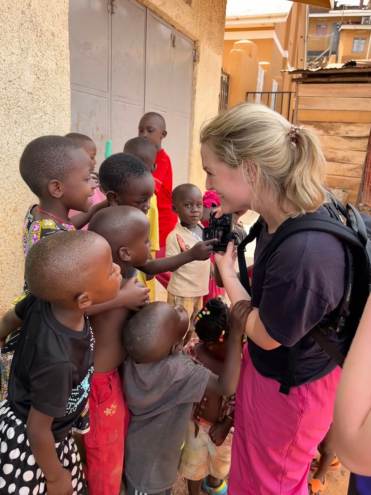 Emily Shafer interacts with children in Katanga, one of the slums of Kampala. “The local kids were mesmerized by my camera and wanted to see and touch it,” she said. “This recurred throughout the three weeks. They loved the camera!”
