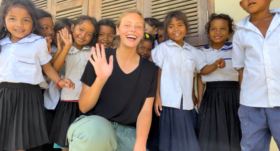 Londyn Gray poses with a group of Cambodian girls she met this summer.