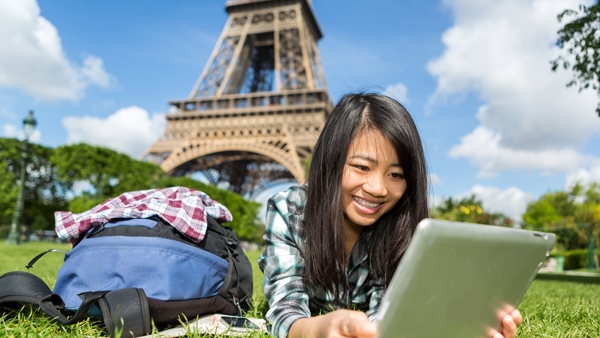 Student on laptop near Eifel Tower