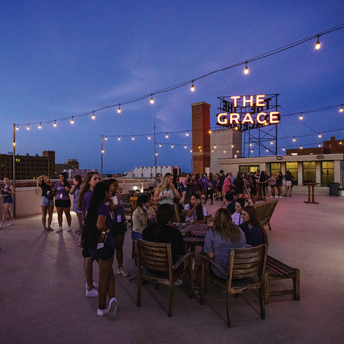Student social on rooftop in the evening -City of Abilene Grace Museusm