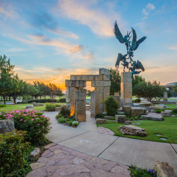 ACU students displaying the Wildcat sign
