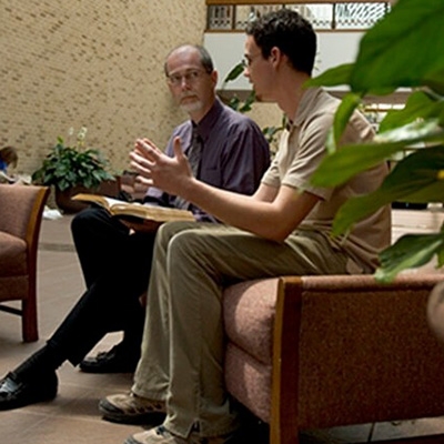 student talking with a faculty member