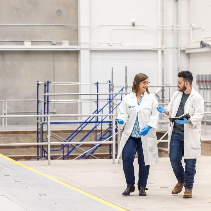 next lab professor walking with student.