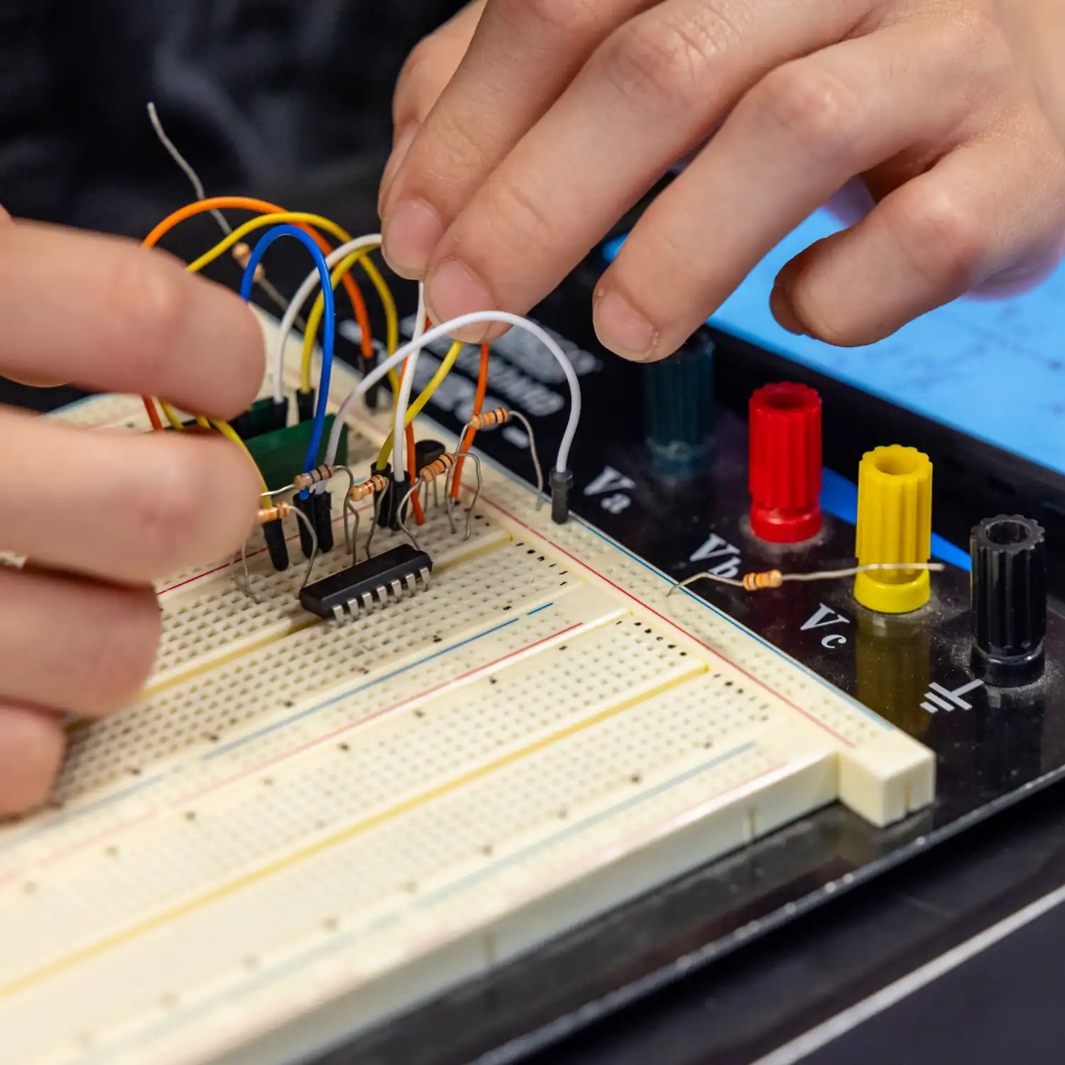 Physics students working with resistors on a programmable resistor board.