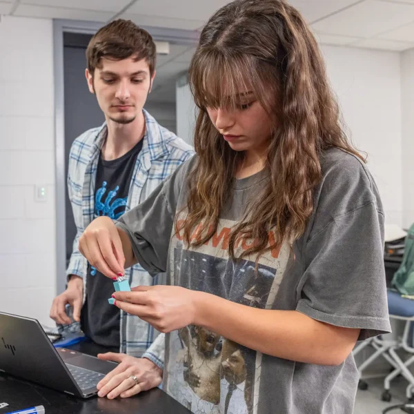 Two physics students working in the lab.