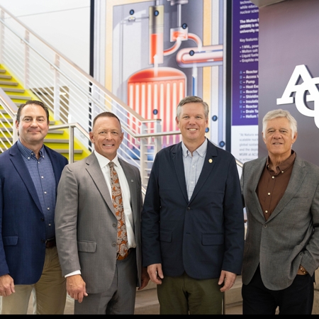 Dr. Rusty Towell, director of NEXT Lab; Dr. Phil Schubert, ACU president; Christopher Hanson, NRC chair; and Douglass Robison, CEO and founder of Natura Resources in the lobby of the Dillard Science and Engineering Research Center.