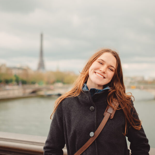 Student posing with Eiffel Tower in the background