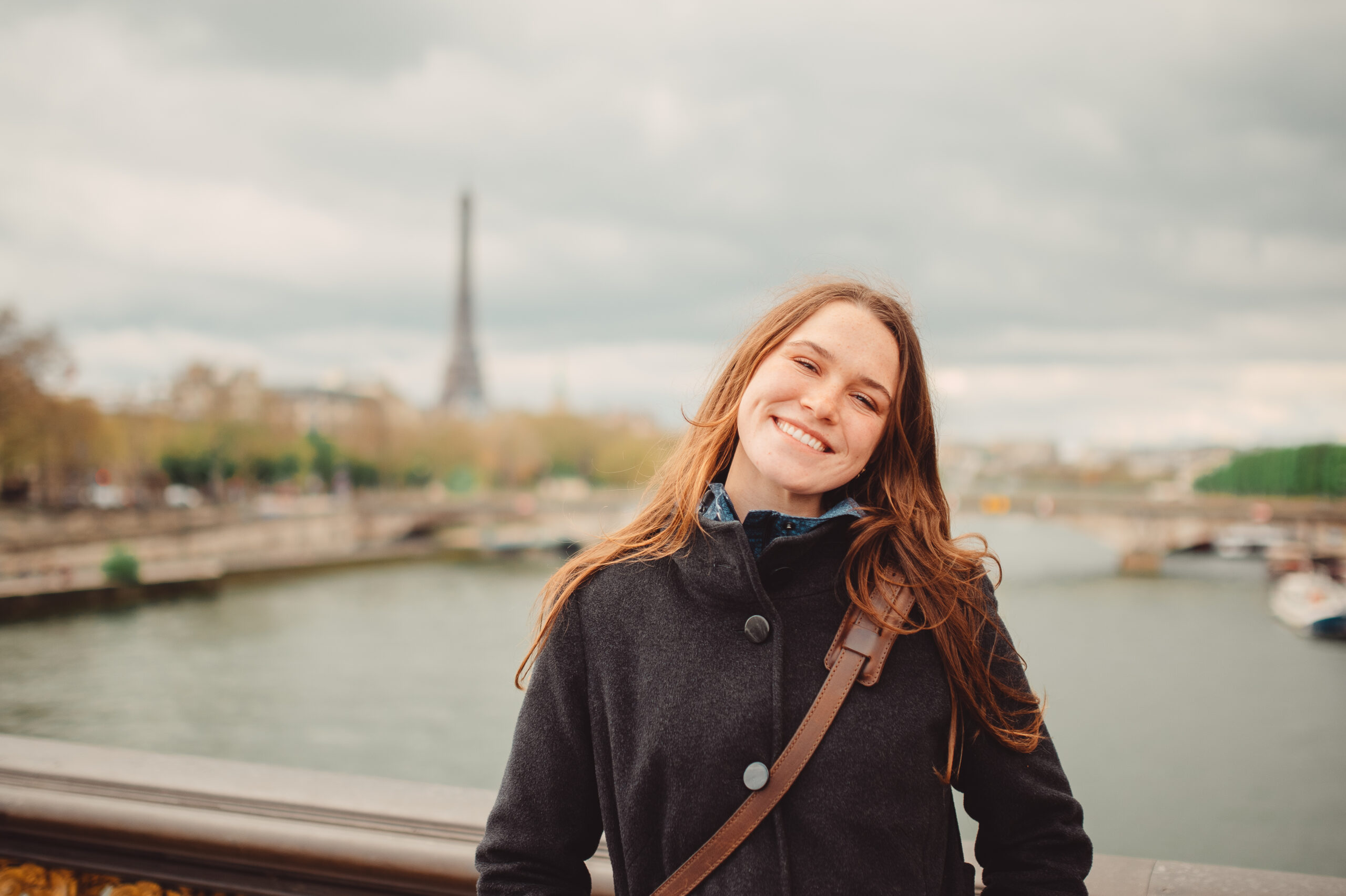 Student posing with Eiffel Tower in the background