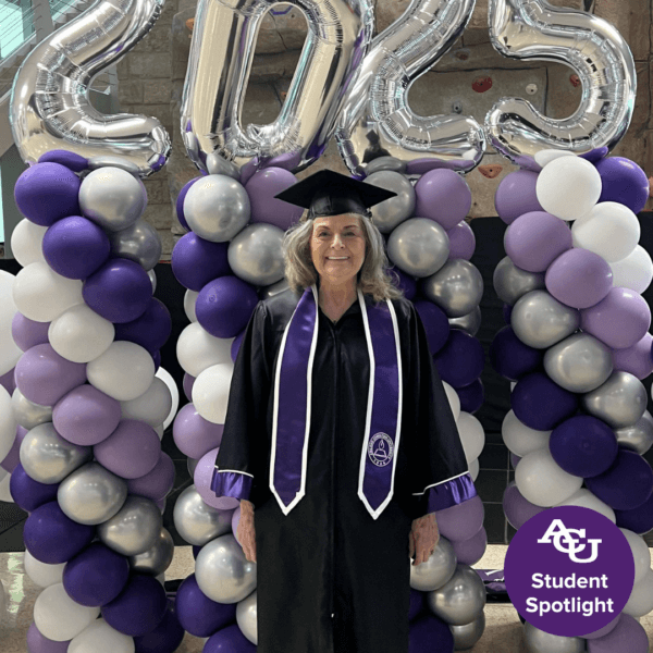 An adult woman in her graduation uniform.