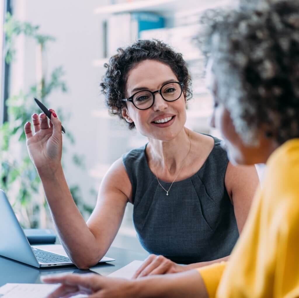 Colleagues discussing project at workplace.
