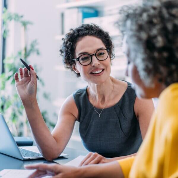 Colleagues discussing project at workplace.