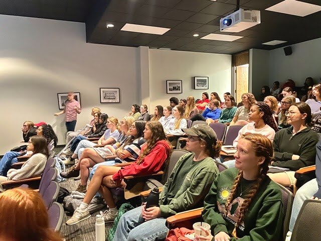 students sitting in a lecture room.