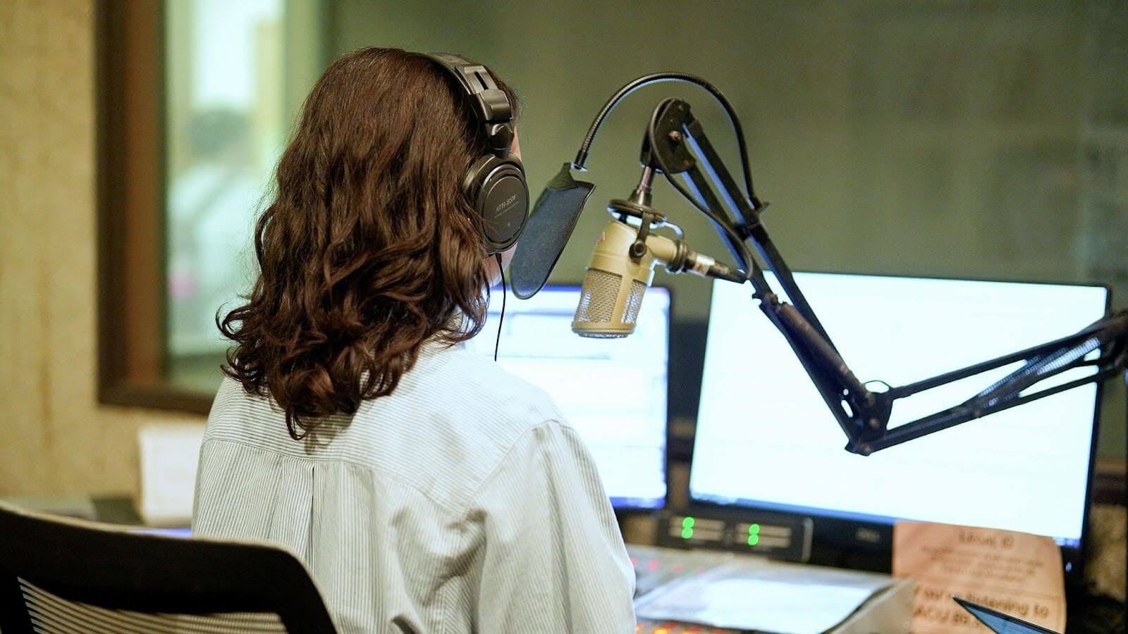 student in recording studio for KACU at Abilene Christian University.