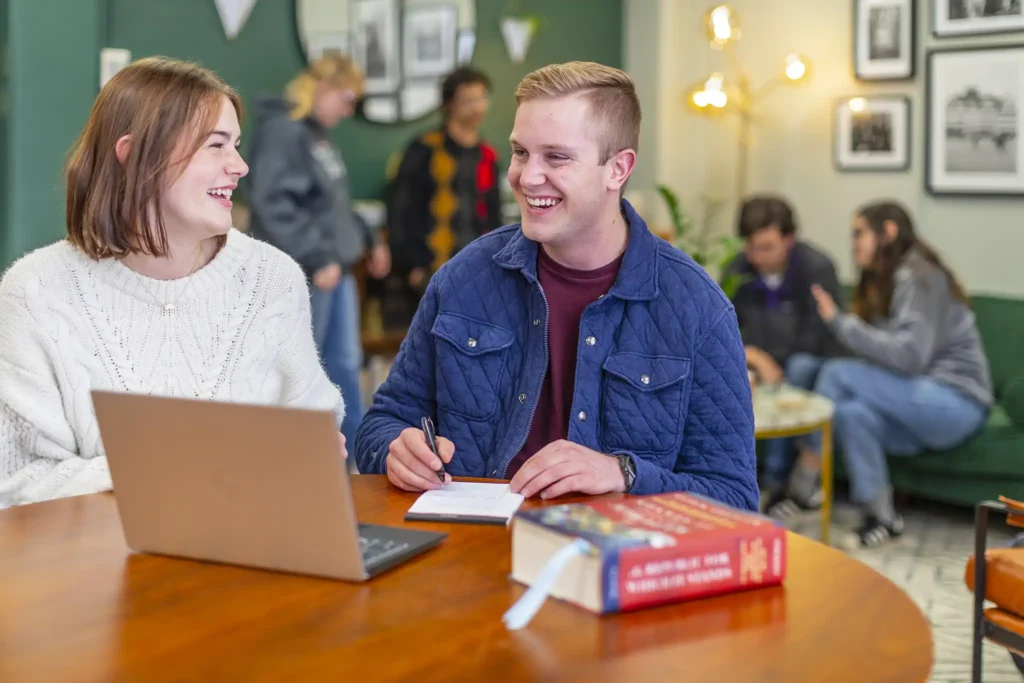 A group of students pause for a laugh during a study session.