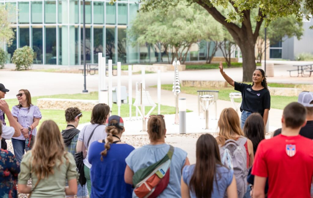 Tour guide shows prospective students around ACU's campus.