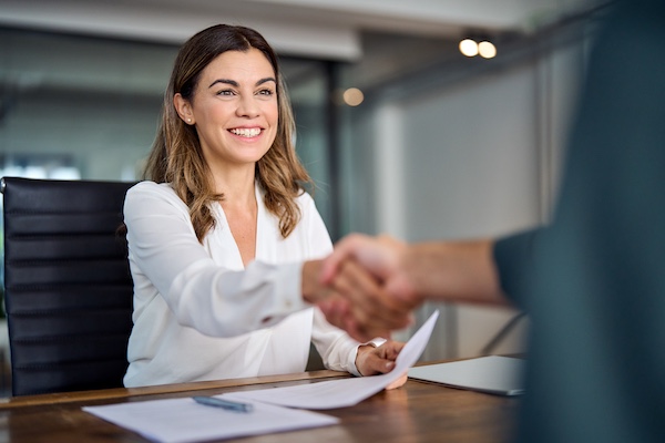 woman shaking hand with person at interview