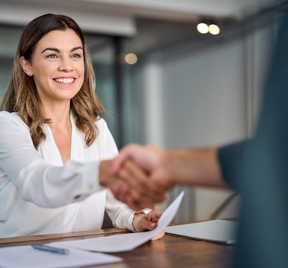 woman shaking hand with person at interview