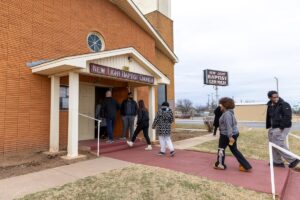 Students, faculty, staff walk into New Light Baptist Church