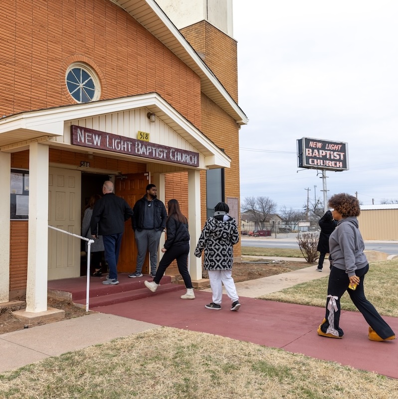 Students, faculty, staff walk into New Light Baptist Church