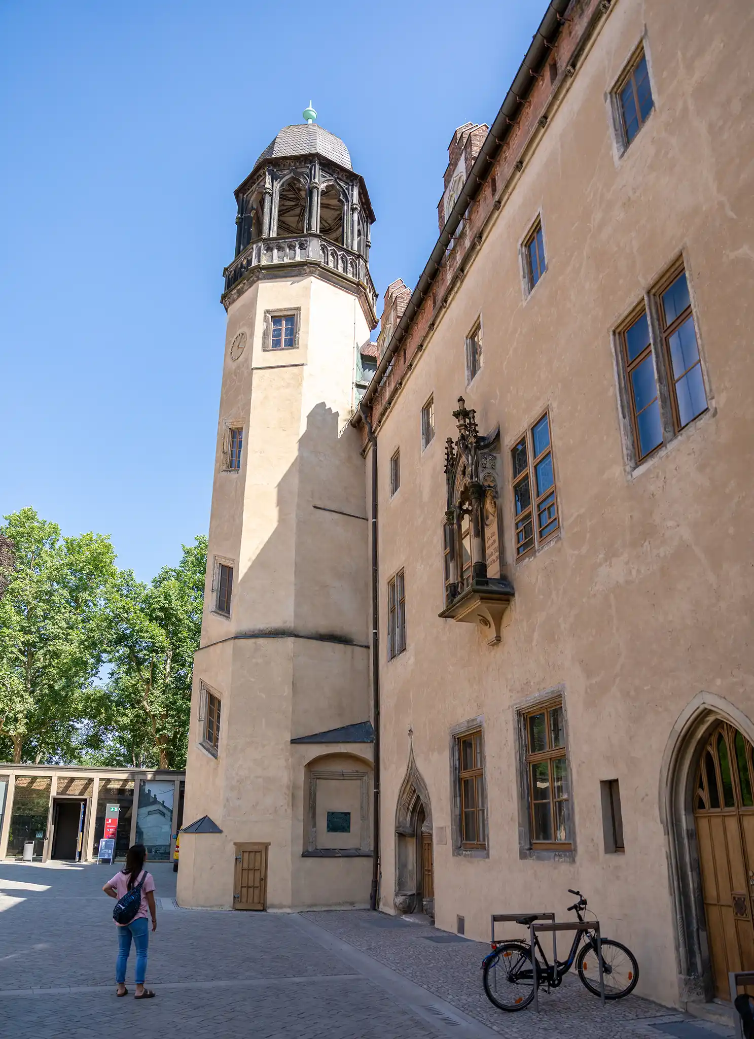 Student looks at scenic church tower in Leipzig, Germany.