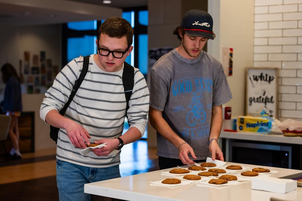 students grabbing cookies from dorm kitchen.