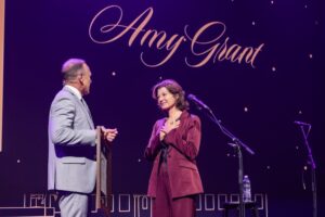 Dr. Phil Schubert presents framed honorary doctorate to entertainer Amy Grant