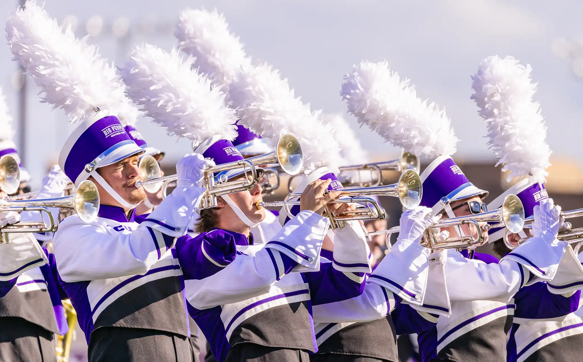 The Big Purple Marching Band trumpet line plays during a halftime performance.