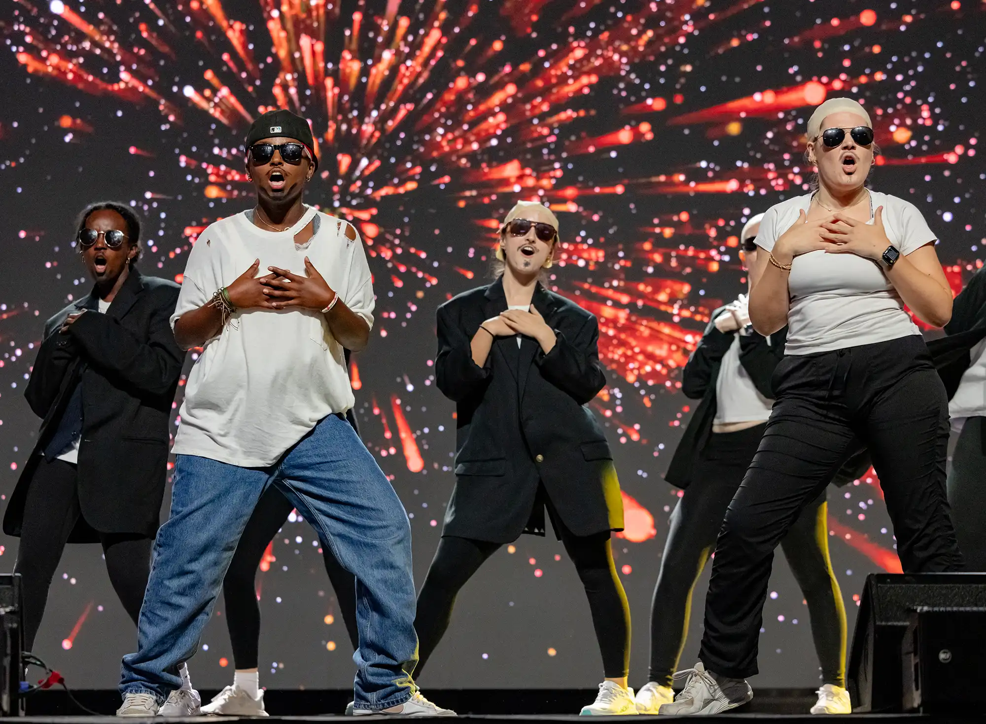 A residence hall group lip-syncs during a Follies performance.