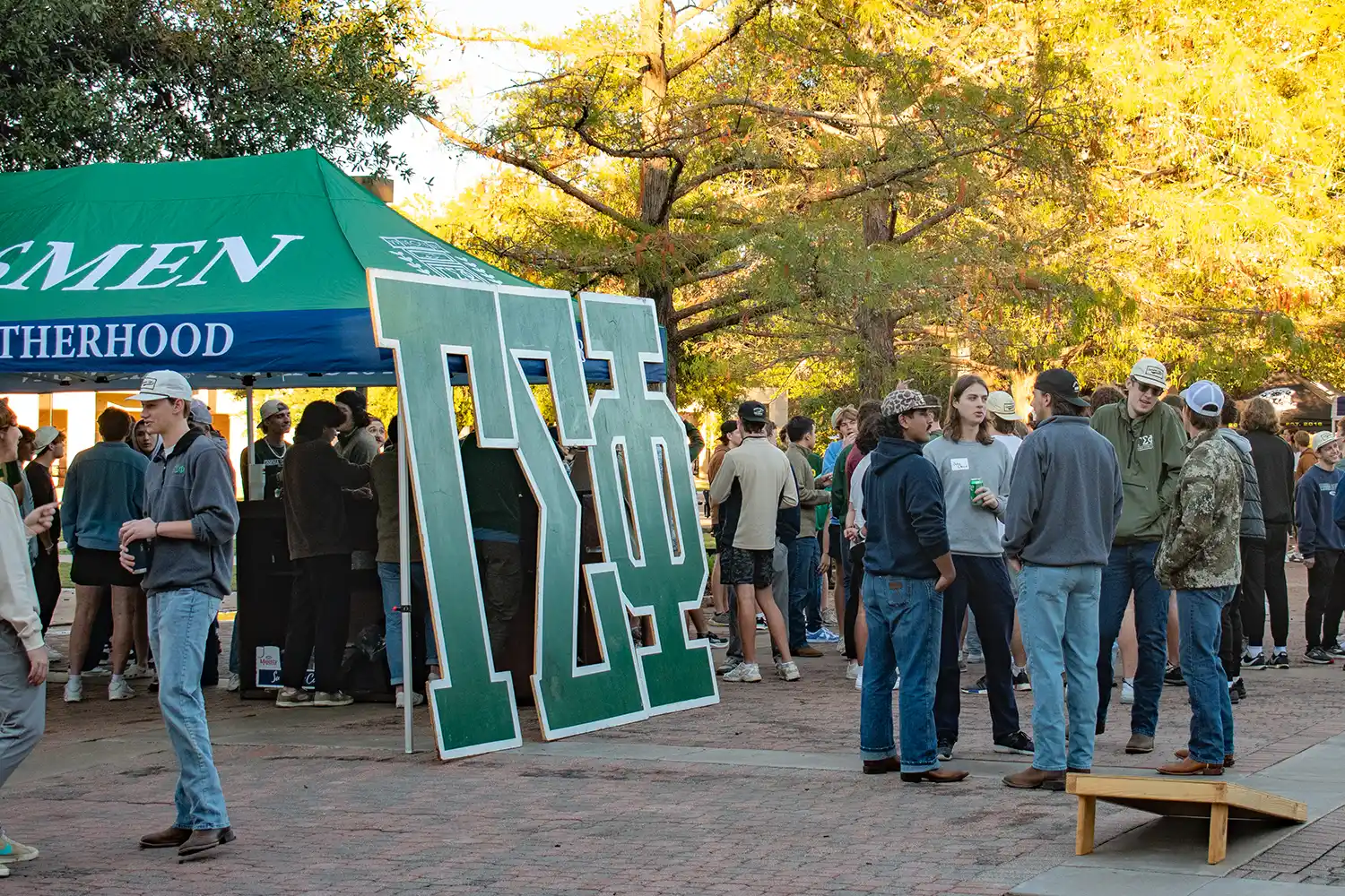 Prospects and members mingle at the Gamma Sigma Phi tent during a rush.